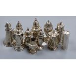 Eleven Victorian and later silver or white metal peppers, including lighthouse, cartridge,