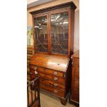 A George III mahogany bureau bookcase with later inlaid carved decoration W.106cm