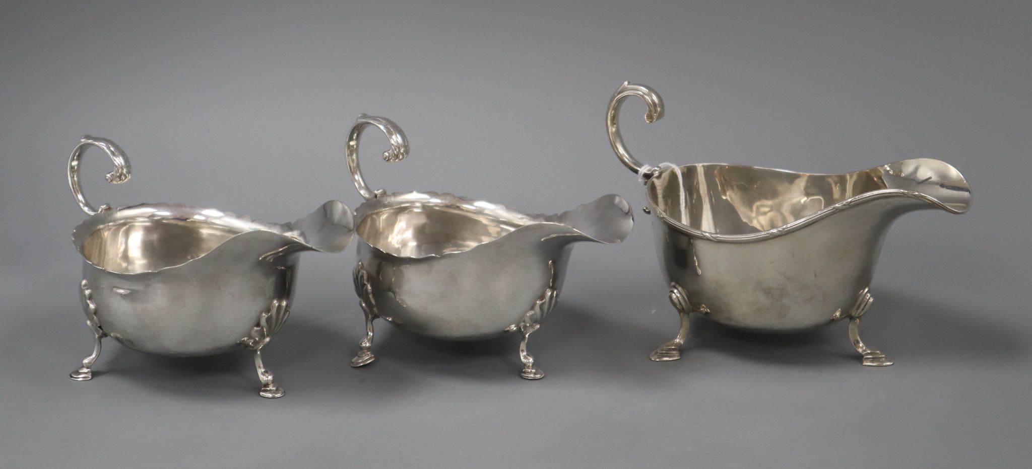 A pair of Edwardian silver sauceboats, Nathan & Hayes, Chester, 1905 and one other silver