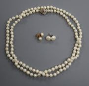 A single strand culture pear necklace with 14k yellow metal and diamond set clasp, and two pairs