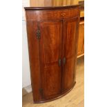 A late 19th century inlaid mahogany bow front hanging corner cupboard W.110cm