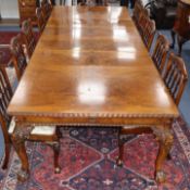 An early 20th century Chippendale revival walnut extending dining table and sideboard ensuite, by