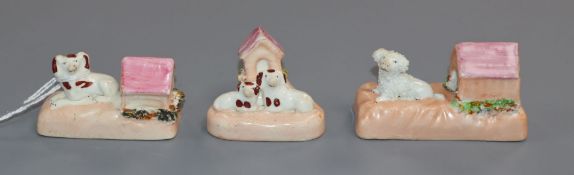 Three Staffordshire porcelain toy figures of spaniels or a poodle with a kennel, c.1830-50, W. 5.