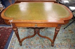 A Victorian walnut and ebonised centre table, inset leather skiver and having bowed ends on turned