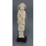 A carved ivory fisherman H.23cm including stand