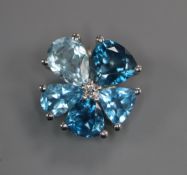 A 14k white metal, blue topaz and diamond set flowerhead pendant, 12mm.