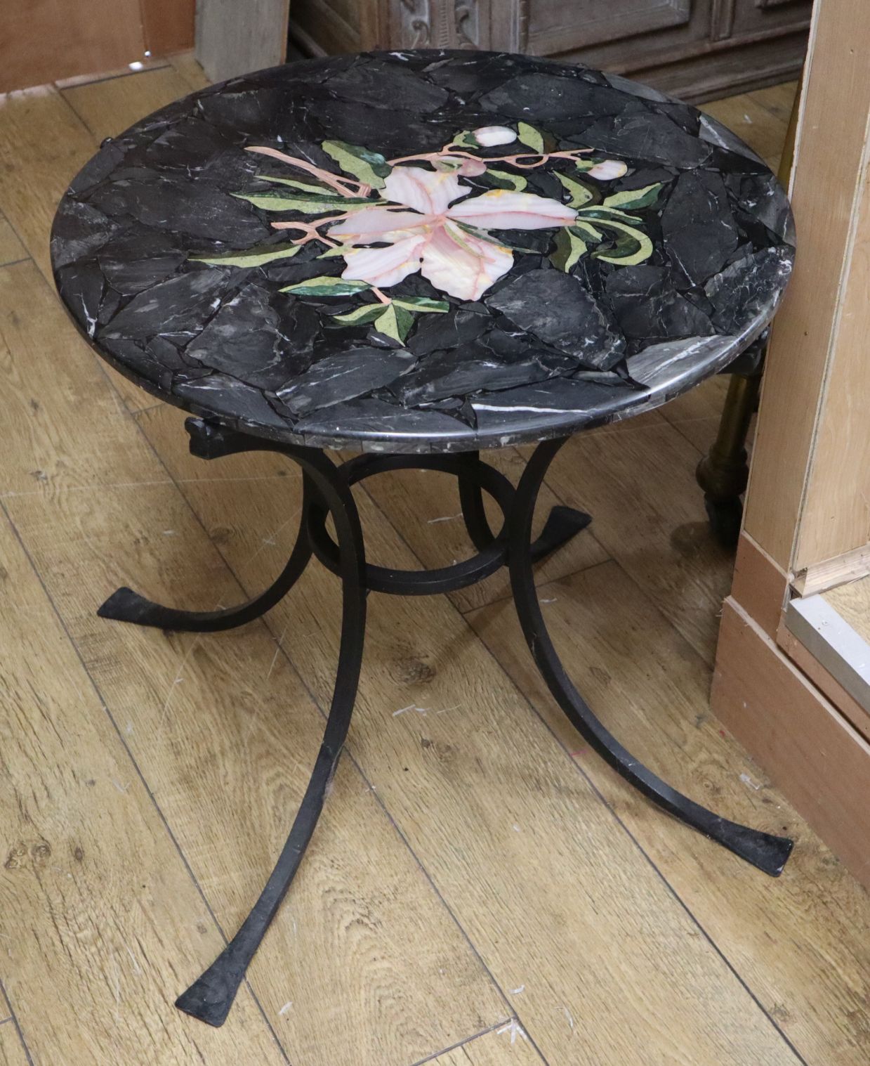 A circular faux marble occasional table on wrought iron base Diam.60cm