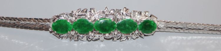 An 18k white metal, cabochon jade and diamond set bracelet, 16.5cm.