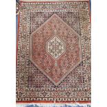 A Persian Bidjar wool rug, ivory ground with terracotta edge 93 x 127cm