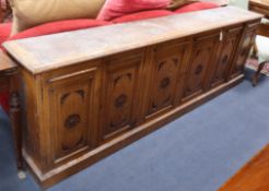 A late Victorian carved oak bookcase base section W.248cm