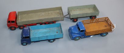 Three Dinky flat beds (blue Guy, brown-blue Leyland Comet and red and green fodder with trailer