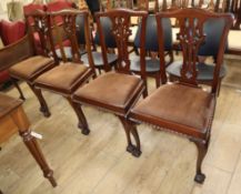A set of four Chippendale style chairs with plain upholstered seats on cabriole legs with claw and