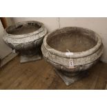 A pair of reconstituted stone garden urns on stands Diam.55cm