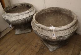 A pair of reconstituted stone garden urns on stands Diam.55cm