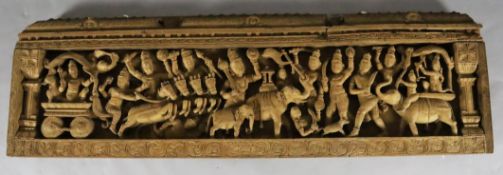 An Indian teak pediment, 19th century carved in high relief with a procession of Hindu deities