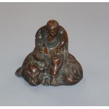 An Oriental patinated metal figure group 6cm high