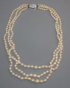 A triple strand graduated cultured pearl necklace, with paste set clasp, 40cm.