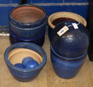 Five blue glazed garden planters and three ball ornaments