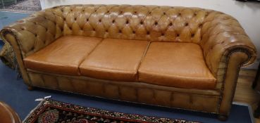An early 20th century tan leather buttoned Chesterfield settee L.214cm