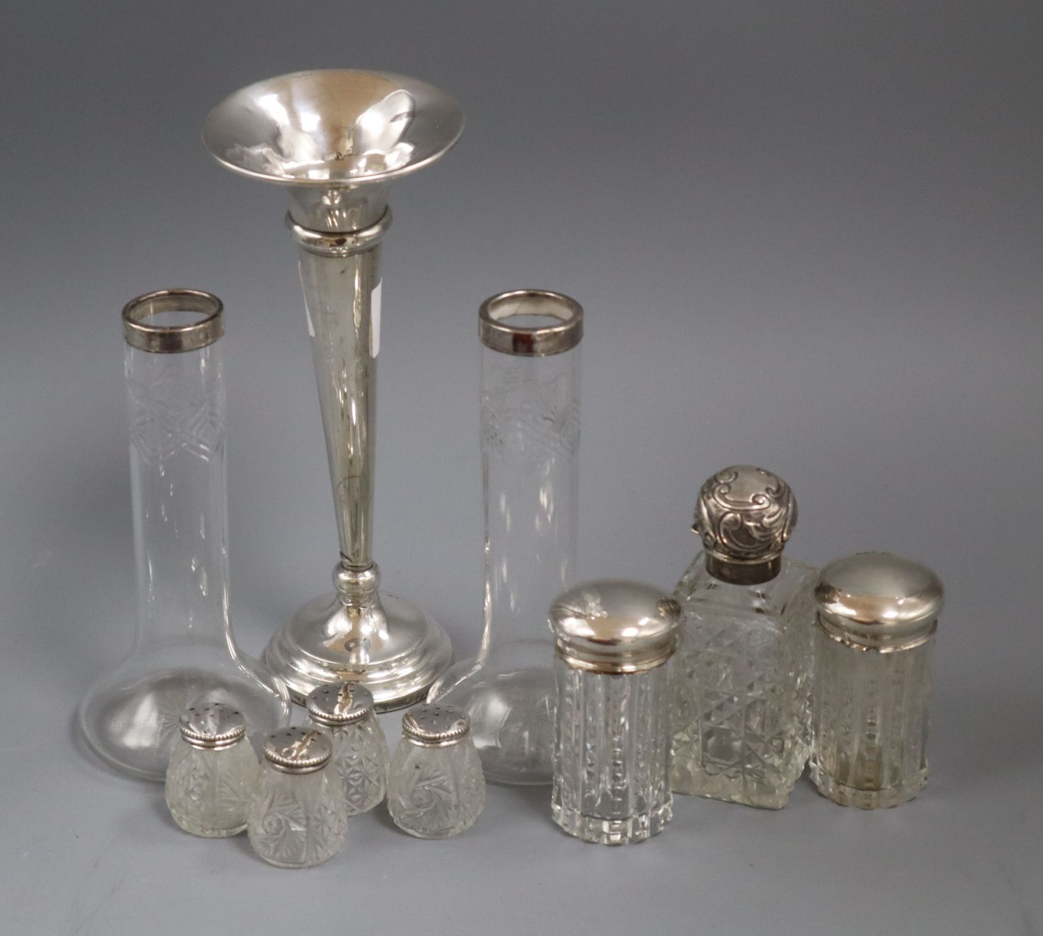 A silver trumpet vase, a silver mounted glass scent bottle and other items.