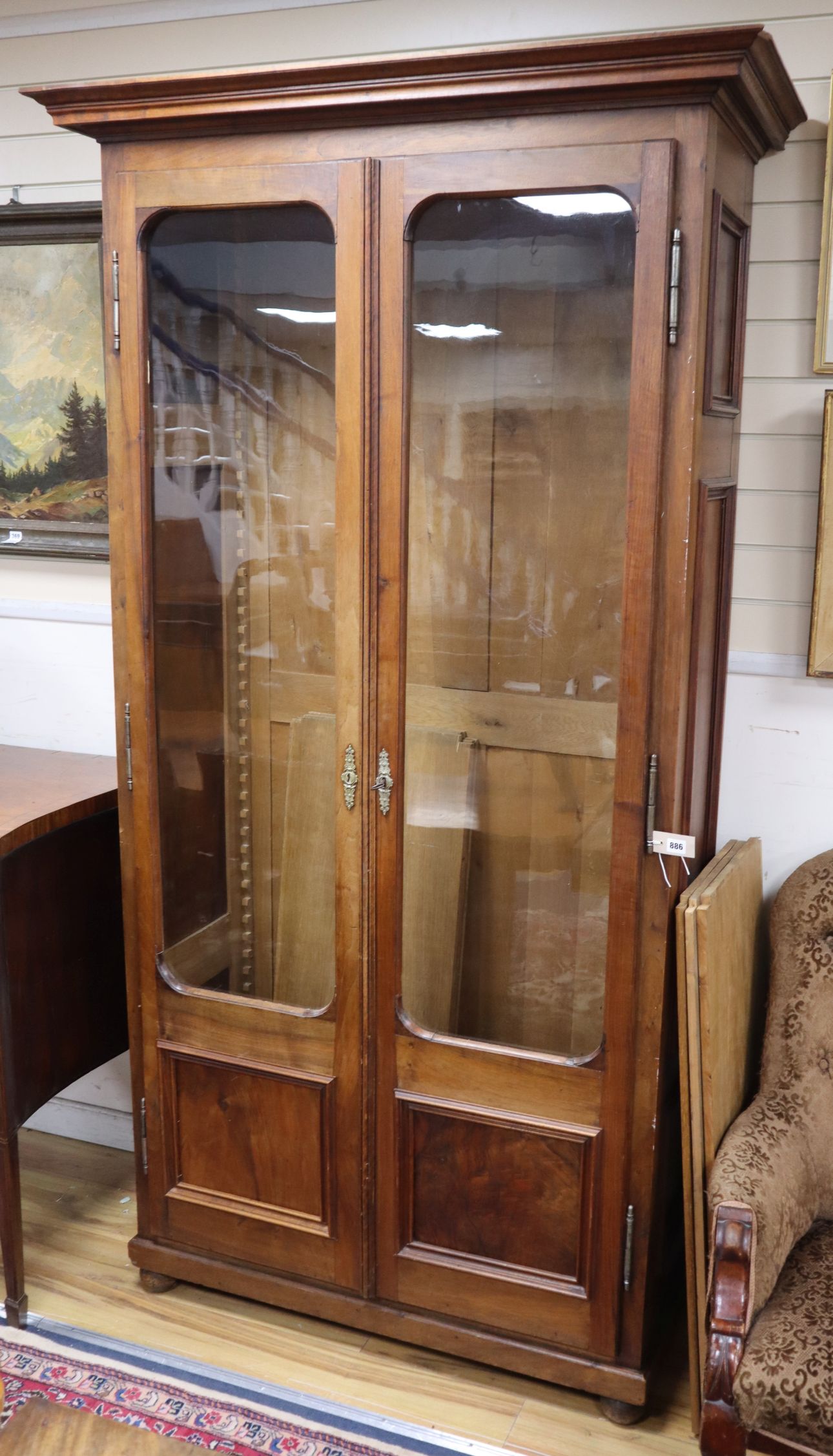 A 19th century Continental walnut glazed bookcase H.226cm