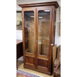 A 19th century Continental walnut glazed bookcase H.226cm