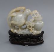 A Chinese pale celadon and russet jade 'quail' carving, wood stand 10cm high including stand