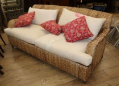 A wove seagrass conservatory sofa W.186cm