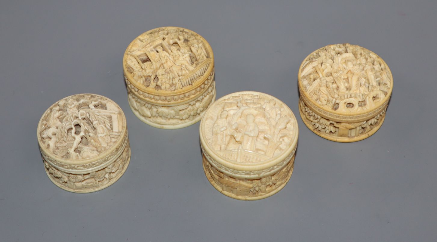 Four carved ivory pill boxes tallest 3cm