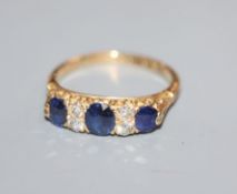 An early 20th century 18ct gold, sapphire and diamond set half hoop ring, size O/P.