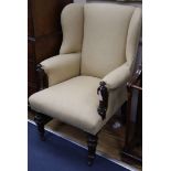 A Victorian rosewood upholstered wing armchair