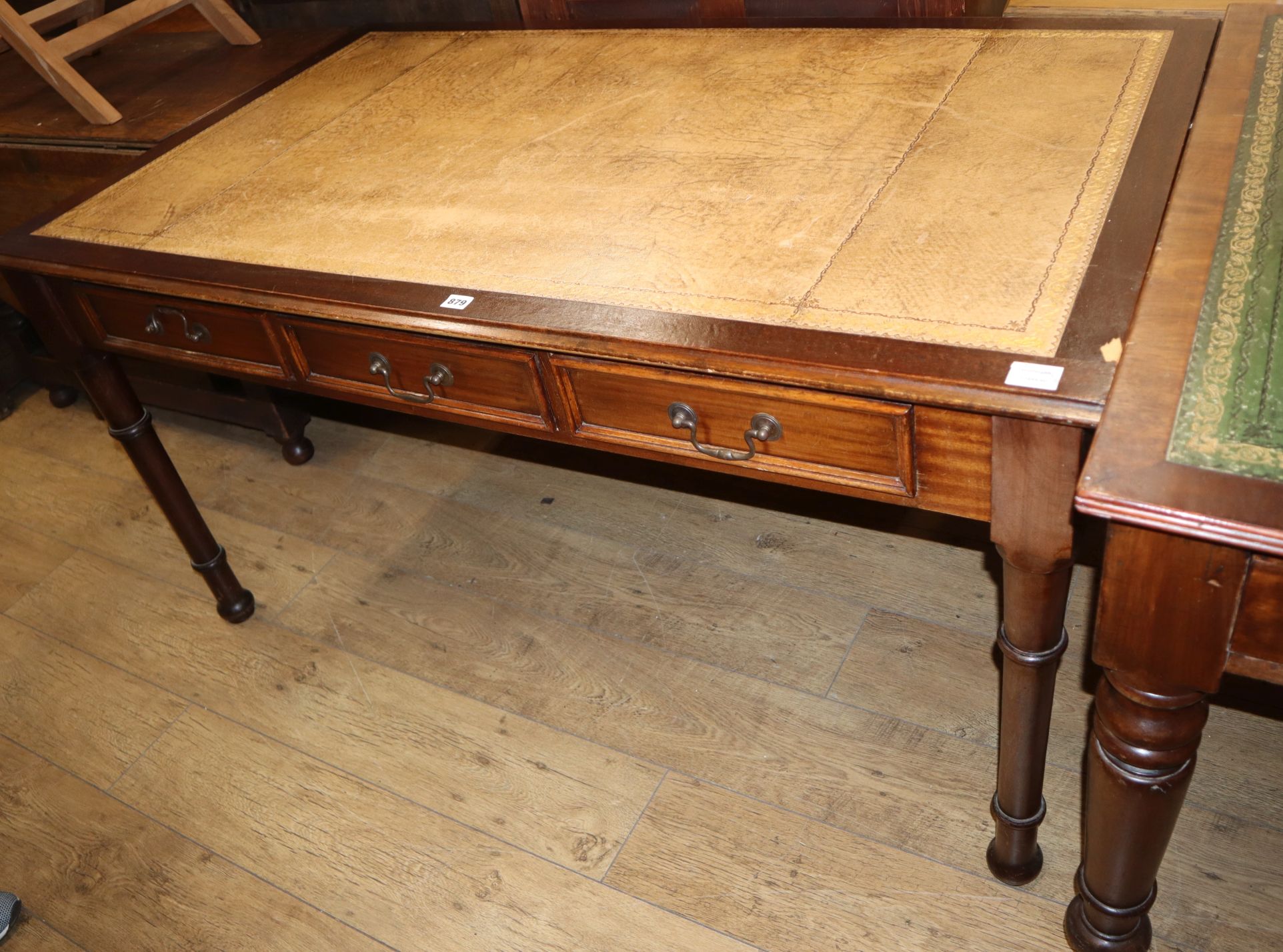 A Victorian style mahogany three drawer writing table W.150cm