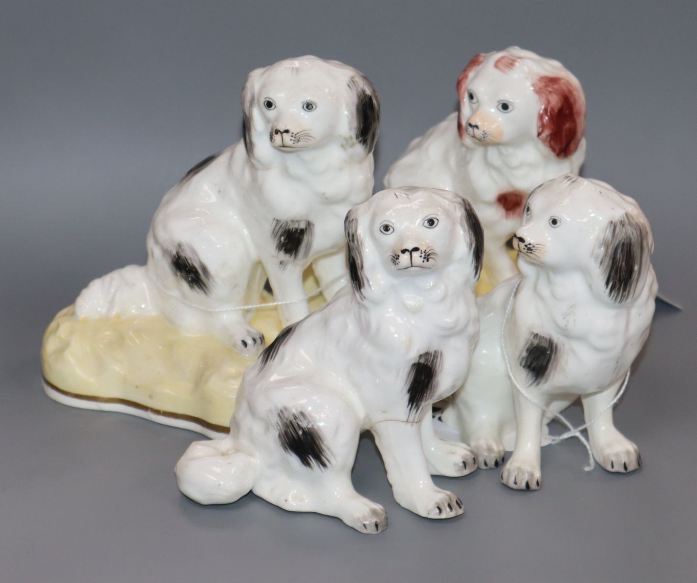 Four Samuel Alcock seated figures of King Charles spaniels, c.1840-50, of larger size, the