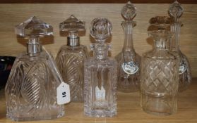A pair of 1930's shaped square-section engraved glass decanters with silver collars and pyramid