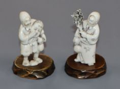 Two carved ivory figures with hardwood stands. tallest 7cm