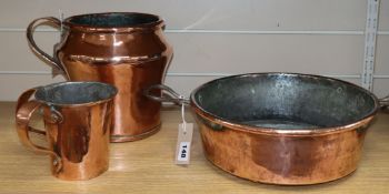 A copper preserve pan, a large copper jug, a double-handed jug and two tankards tallest 23cm