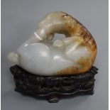 A Chinese pale celadon and russet jade horse, wood stand 9cm high including stand