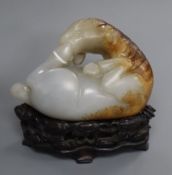 A Chinese pale celadon and russet jade horse, wood stand 9cm high including stand