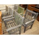 A set of weathered teak garden elbow chairs