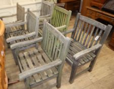 A set of weathered teak garden elbow chairs