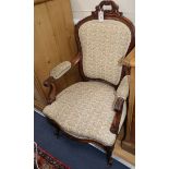 A Victorian mahogany spoonback elbow chair