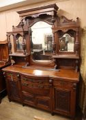 A late Victorian carved walnut bowfront mirror back sideboard W.182cm