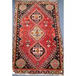 A Persian Qashqai wool rug, red ground 109 x 172cm