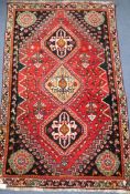 A Persian Qashqai wool rug, red ground 109 x 172cm