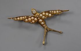 A Victorian 15ct, seed pearl and diamond set swallow brooch, 49mm.