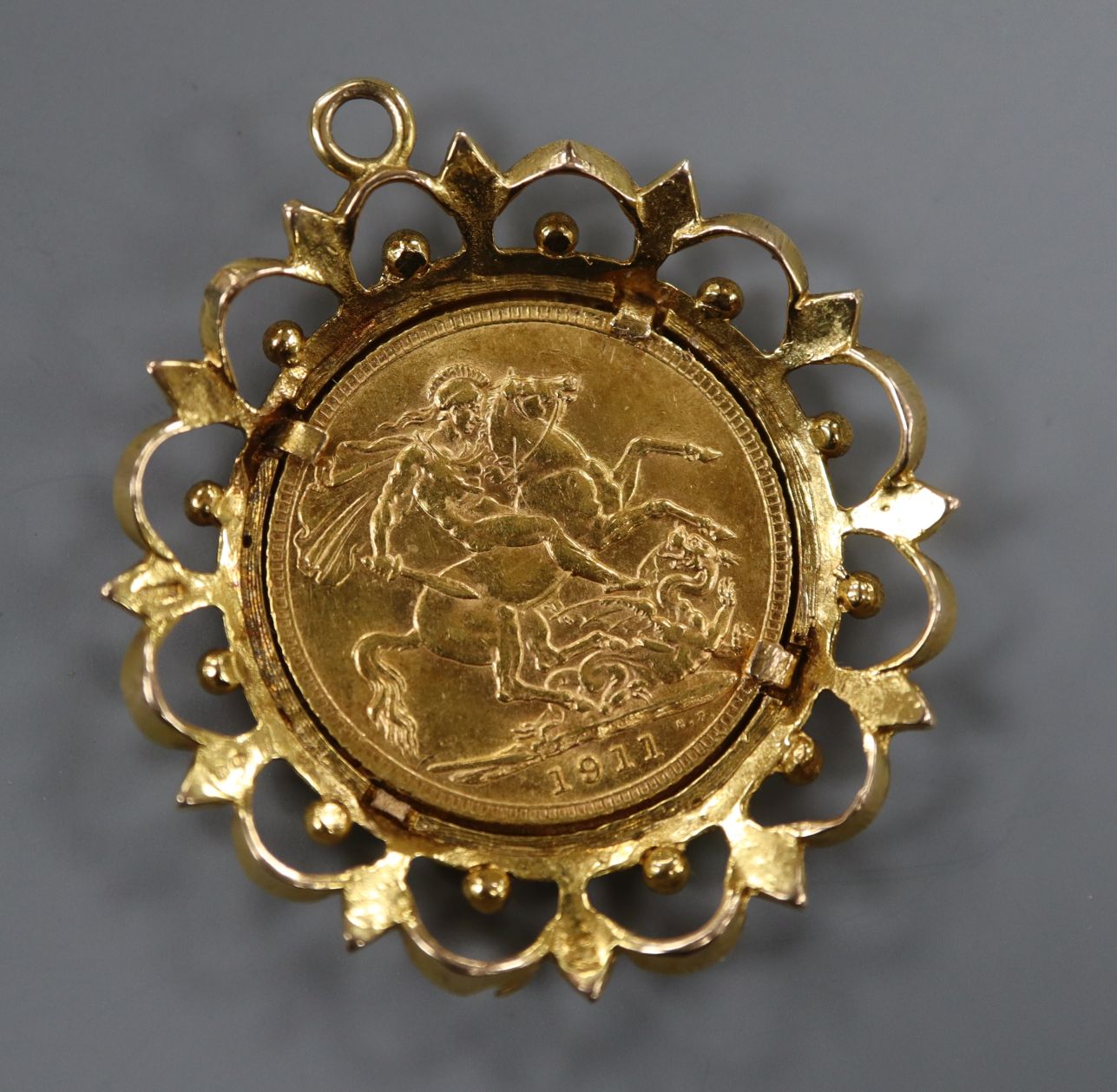 A George V 1911 gold full sovereign, in 9ct gold pendant mount.