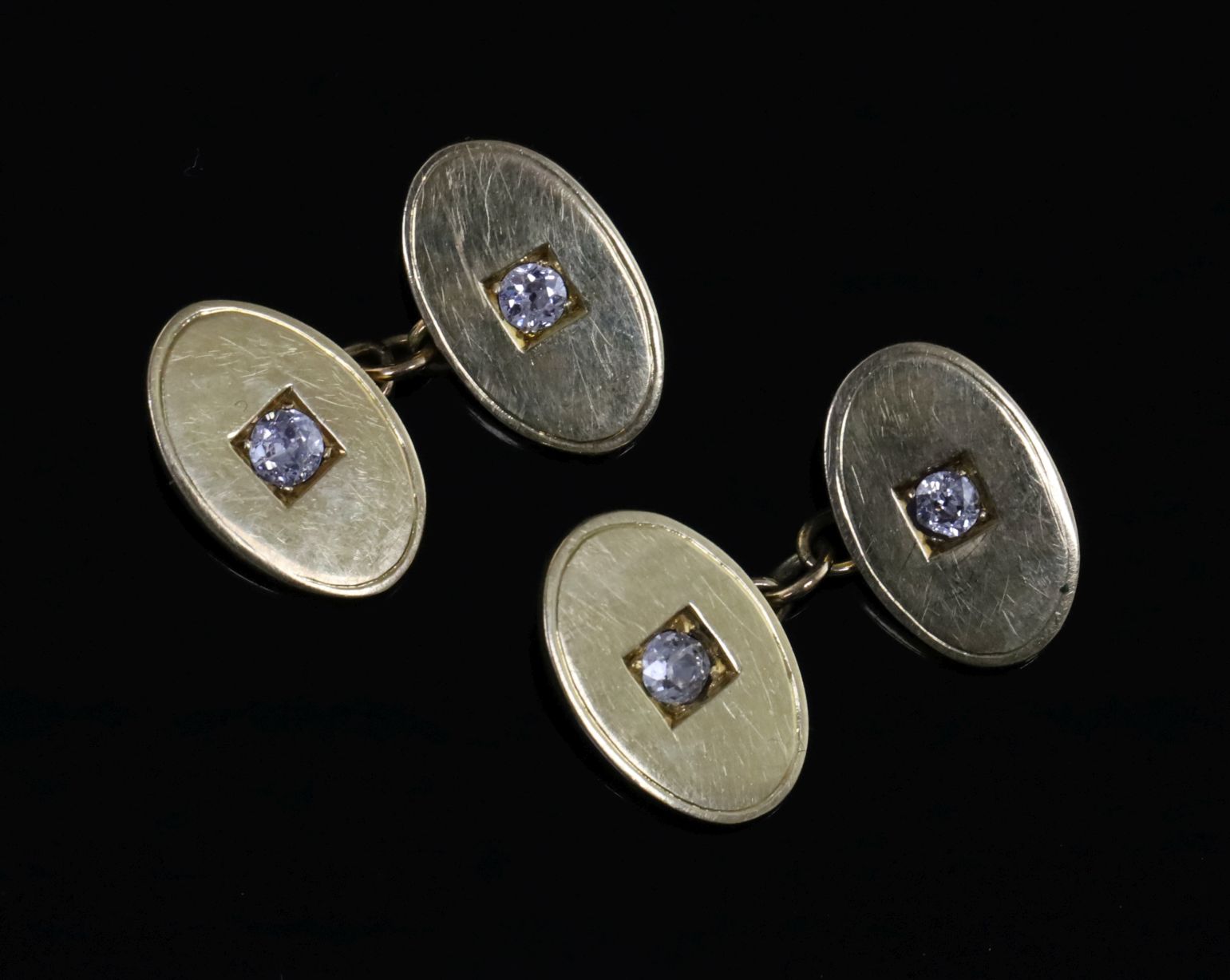 A pair of 18ct gold and diamond set oval cufflinks, in gilt tooled leather case.