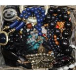 A group of assorted costume jewellery including necklaces and beads and a pair of opera glasses.