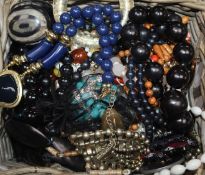A group of assorted costume jewellery including necklaces and beads and a pair of opera glasses.