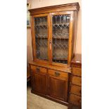 A late Victorian glazed walnut bookcase cupboard W.103cm